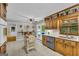 Spacious kitchen features light countertops, stainless steel appliances, and views of the backyard pool at 603 Lakewood Dr, Social Circle, GA 30025