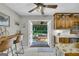 View from kitchen to a backyard patio featuring an outdoor seating area with string lights at 603 Lakewood Dr, Social Circle, GA 30025