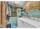 Well-organized laundry room with washer, dryer, and ample storage space at 603 Lakewood Dr, Social Circle, GA 30025
