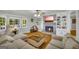 Spacious living room featuring a brick fireplace, built-in shelving, and a comfortable seating area at 603 Lakewood Dr, Social Circle, GA 30025