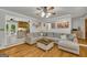 Bright living room with a comfortable sectional sofa and views into the kitchen with an attached breakfast area at 603 Lakewood Dr, Social Circle, GA 30025