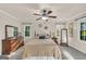 Relaxing main bedroom with neutral tones, ceiling fan, and bright windows at 603 Lakewood Dr, Social Circle, GA 30025