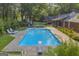 Relaxing pool area, complete with diving board, lounge chairs, and outdoor seating, perfect for enjoying the sun at 603 Lakewood Dr, Social Circle, GA 30025