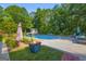 Outdoor pool and backyard area with a fire pit, outdoor seating, and landscaping at 603 Lakewood Dr, Social Circle, GA 30025