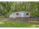 Shed in a backyard with a garage door, a door and two windows at 603 Lakewood Dr, Social Circle, GA 30025