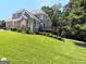 Backyard featuring a spacious deck, lush lawn, and mature landscaping, perfect for outdoor living at 1292 Hidden Spirit Trl, Lawrenceville, GA 30045