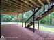 Stunning backyard patio and stairs with open beam structure and lush green surroundings and shade at 1292 Hidden Spirit Trl, Lawrenceville, GA 30045