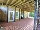 Spacious backyard patio with brick flooring, multiple doors and windows, offering outdoor relaxation and entertainment at 1292 Hidden Spirit Trl, Lawrenceville, GA 30045