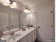 Bathroom features a double vanity with a large mirror and white cabinets at 1292 Hidden Spirit Trl, Lawrenceville, GA 30045