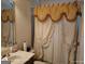 Cozy bathroom featuring a sink and decorative shower curtain with matching valance at 1292 Hidden Spirit Trl, Lawrenceville, GA 30045
