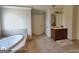 Bright bathroom featuring a soaking tub and a wooden vanity with double sinks at 1292 Hidden Spirit Trl, Lawrenceville, GA 30045