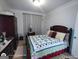 Comfortable bedroom with a queen-sized bed and a patterned quilt at 1292 Hidden Spirit Trl, Lawrenceville, GA 30045