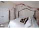 Cozy bedroom featuring a canopy bed with a nearby closet and a window for soft lighting at 1292 Hidden Spirit Trl, Lawrenceville, GA 30045