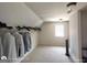 Spacious walk-in closet featuring built-in shelving, plenty of hanging storage, and a window at 1292 Hidden Spirit Trl, Lawrenceville, GA 30045