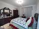 Cozy bedroom featuring a queen-sized bed with a wooden frame at 1292 Hidden Spirit Trl, Lawrenceville, GA 30045