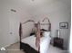 Bright bedroom with canopy bed, side tables, and soft light from a nearby window at 1292 Hidden Spirit Trl, Lawrenceville, GA 30045