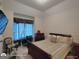 Bedroom with a decorative window, a desk, and a chair near a queen bed at 1292 Hidden Spirit Trl, Lawrenceville, GA 30045