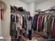 Walk-in closet filled with clothing and accessories on racks and shelves at 1292 Hidden Spirit Trl, Lawrenceville, GA 30045