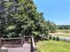 Wooden deck featuring outdoor space with a view of a well-manicured lawn and wooded area at 1292 Hidden Spirit Trl, Lawrenceville, GA 30045