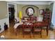 Spacious dining room featuring hardwood floors, ample seating, and a stylish display cabinet at 1292 Hidden Spirit Trl, Lawrenceville, GA 30045
