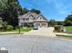 Beautiful two-story brick home featuring a well-manicured lawn, mature trees, and a two-car garage at 1292 Hidden Spirit Trl, Lawrenceville, GA 30045