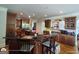 Open kitchen with a central island, stainless steel refrigerator, and rich wooden cabinetry at 1292 Hidden Spirit Trl, Lawrenceville, GA 30045