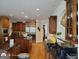 Gourmet kitchen features wooden cabinets, stainless steel appliances, granite countertops, and hardwood floors at 1292 Hidden Spirit Trl, Lawrenceville, GA 30045