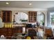 Gourmet kitchen with tile backsplash, wooden cabinets, and an open layout at 1292 Hidden Spirit Trl, Lawrenceville, GA 30045