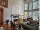 Cozy living room with a fireplace, hardwood floors, and large windows offering natural light at 1292 Hidden Spirit Trl, Lawrenceville, GA 30045