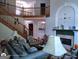 Cozy living room featuring a fireplace with mantel, hardwood floors, and elegant furniture at 1292 Hidden Spirit Trl, Lawrenceville, GA 30045