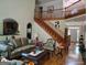 Open-concept living room with a staircase, hardwood floors, and sophisticated decor at 1292 Hidden Spirit Trl, Lawrenceville, GA 30045