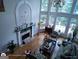 Bright, open living room with large windows, fireplace, hardwood floors, and comfortable seating at 1292 Hidden Spirit Trl, Lawrenceville, GA 30045