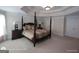A cozy main bedroom boasts a four-poster bed, tray ceiling, bedside tables and generous closet space at 1292 Hidden Spirit Trl, Lawrenceville, GA 30045
