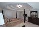 Beautiful main bedroom features a four-poster bed, tray ceiling, dresser with mirror, and ample storage at 1292 Hidden Spirit Trl, Lawrenceville, GA 30045