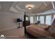 Expansive main bedroom featuring tray ceiling, four-poster bed, and abundant natural light through draped windows at 1292 Hidden Spirit Trl, Lawrenceville, GA 30045