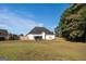 Expansive backyard featuring lush green grass, a wood fence, and a well-maintained lawn at 609 Alyssa Ct, Locust Grove, GA 30248