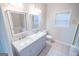 Double sink vanity with marble countertop in bright bathroom with tile floor at 609 Alyssa Ct, Locust Grove, GA 30248