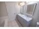Double sink vanity with marble countertop in bathroom with tile flooring and bathtub at 609 Alyssa Ct, Locust Grove, GA 30248