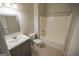 Bathroom features a modern sink vanity, toilet, mirror, and a tub shower at 609 Alyssa Ct, Locust Grove, GA 30248