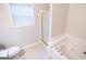 Bright bathroom featuring a shower and a jetted bathtub with gold trim at 609 Alyssa Ct, Locust Grove, GA 30248
