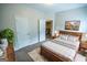 Bedroom with wood floors, neutral walls, a decorative plant, and ensuite washer and dryer at 609 Alyssa Ct, Locust Grove, GA 30248