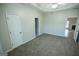Carpeted bedroom with neutral walls and a trey ceiling and multiple entry doors at 609 Alyssa Ct, Locust Grove, GA 30248