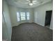 Spacious bedroom with carpet, a tray ceiling, and a large bay window at 609 Alyssa Ct, Locust Grove, GA 30248