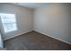 Bedroom with neutral walls and carpet, bright window offering natural light into the space at 609 Alyssa Ct, Locust Grove, GA 30248