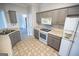 Bright kitchen featuring gray cabinets, white appliances, and a gas range at 609 Alyssa Ct, Locust Grove, GA 30248