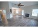 Spacious living room with modern flooring, fireplace, and an open layout connecting to the dining area at 609 Alyssa Ct, Locust Grove, GA 30248