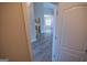 Open floor plan shows wood floors leading to the kitchen and a bright living space at 609 Alyssa Ct, Locust Grove, GA 30248