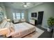 Elegant main bedroom suite with tray ceiling, bay window, and access to ensuite bathroom at 609 Alyssa Ct, Locust Grove, GA 30248