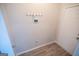 Well lit mud room features coat hooks and a white door at 609 Alyssa Ct, Locust Grove, GA 30248