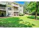 Spacious backyard with green lawn, mature trees, and multi-level decks at 512 Las Brasis Ct, Peachtree City, GA 30269